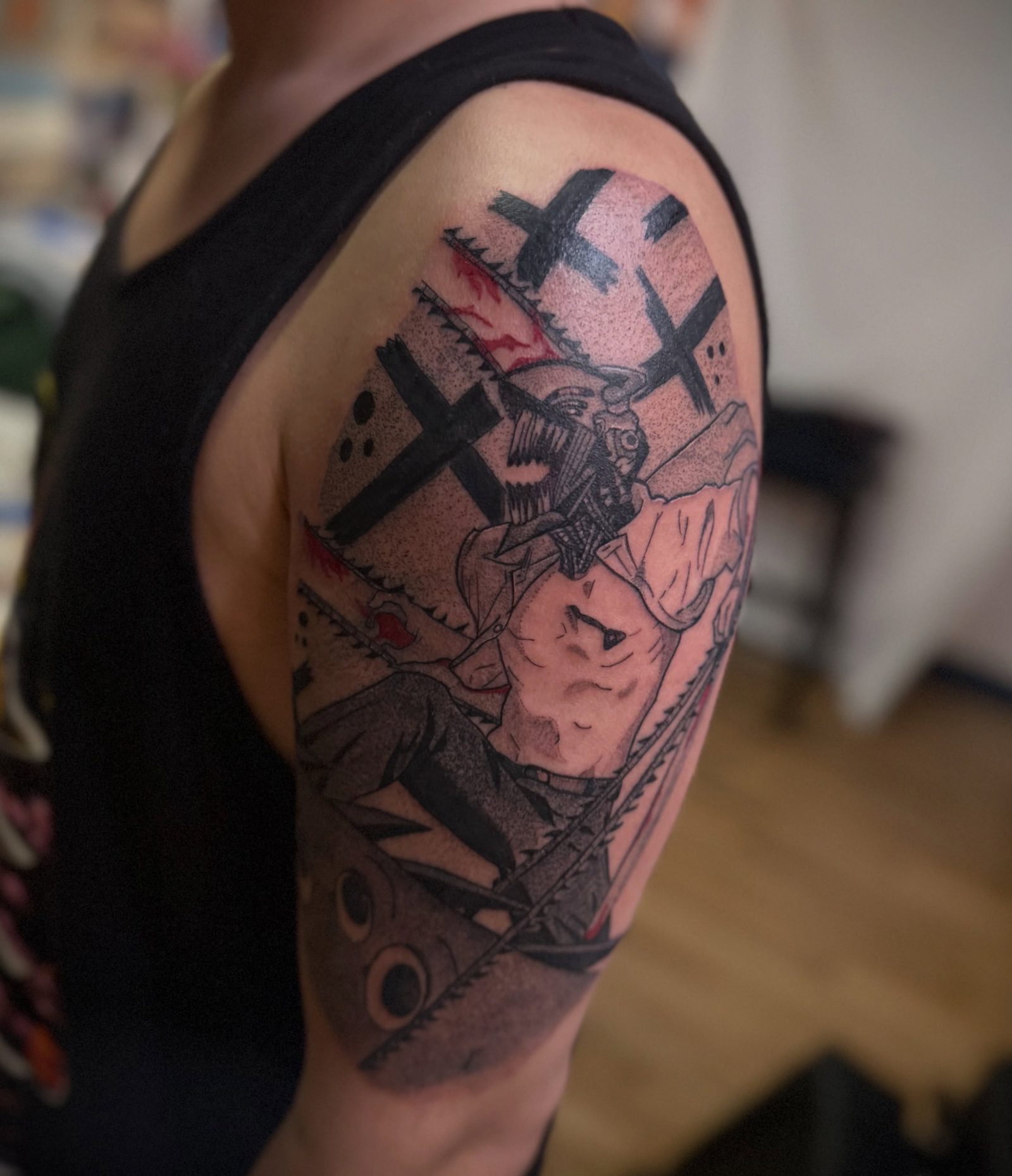 Denji from Chainsaw Man tattooed across a shoulder