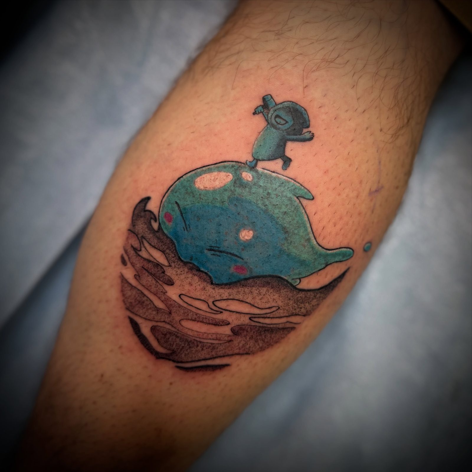 A Reincarnated as a Slime and One Piece crossover tattooed in colour on a calf