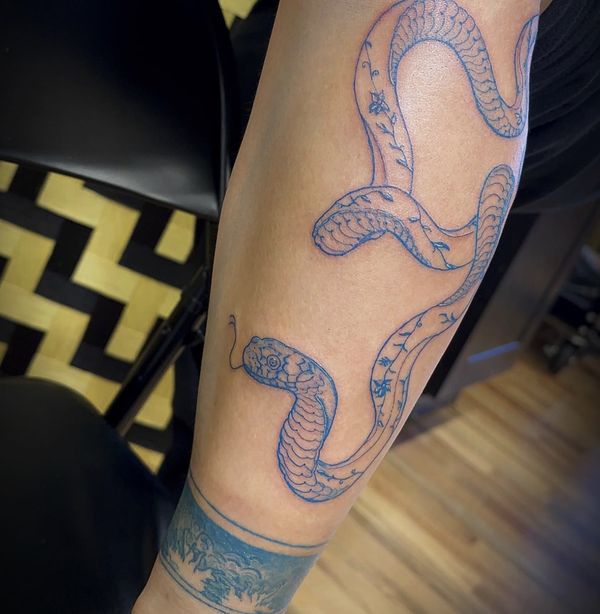 Blue Floral Snake tattoo by LoLo, on the forearm