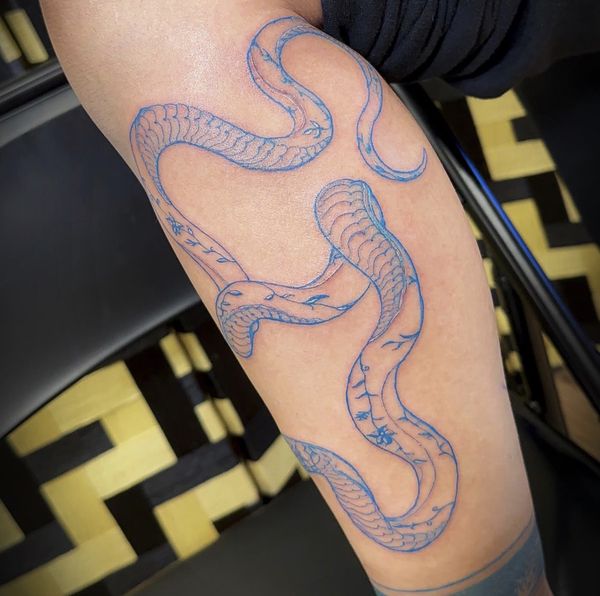 Blue Floral Snake tattoo by LoLo, on the forearm